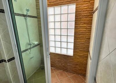 Modern bathroom with glass shower and decorative stone wall