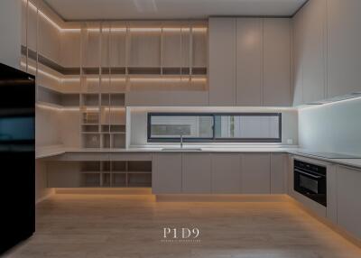 Modern kitchen with built-in appliances and wooden cabinets