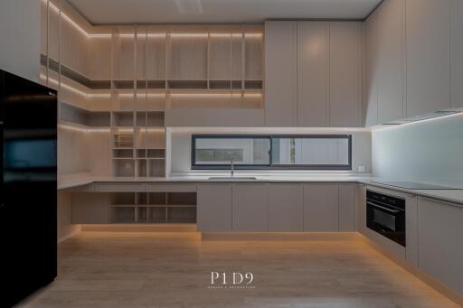 Modern kitchen with built-in appliances and wooden cabinets