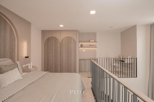 Spacious modern bedroom with en-suite kitchenette and balcony access