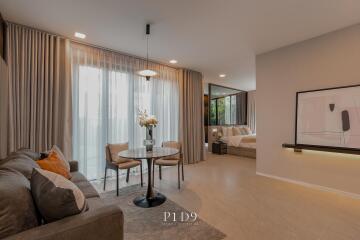 Modern spacious living room with dining area and adjacent bedroom
