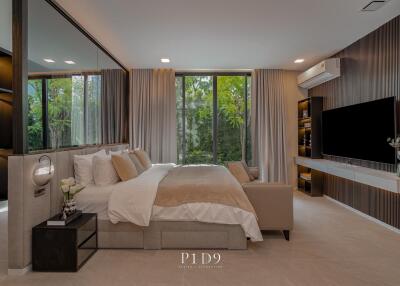 Modern master bedroom with large windows and stylish interior design