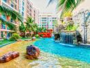 Luxurious apartment complex pool with waterfalls and lush landscaping