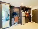 Compact modern kitchen with integrated appliances and adjacent bedroom view