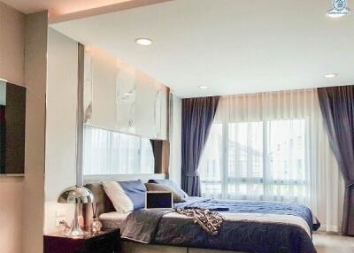 Elegant modern bedroom with large window and stylish decor