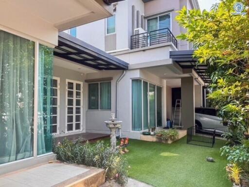 Modern home facade with patio and garden