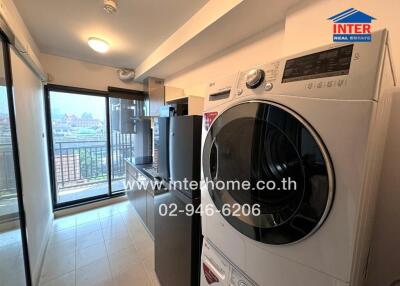 Compact laundry room with modern appliances and balcony access