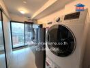 Compact laundry room with modern appliances and balcony access