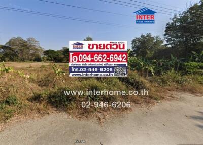 Real estate sign in front of vacant land