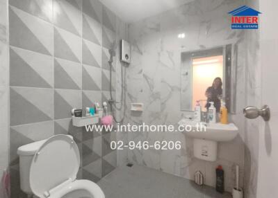 Modern bathroom interior with gray and white tiles and essential amenities