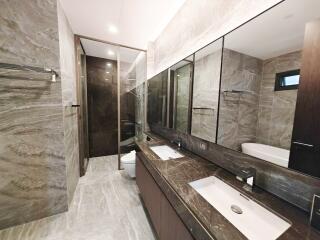 Modern bathroom with marble finish and dual vanities