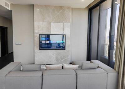 Modern living room with large windows and a mounted television