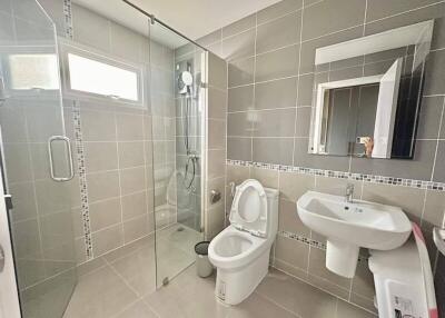 Modern bathroom with glass shower enclosure and white fixtures