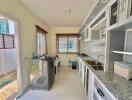 Modern kitchen with ample cabinetry and stainless steel appliances