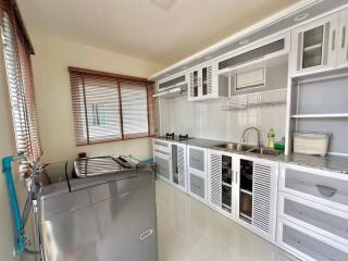 Modern kitchen with white cabinetry and stainless steel appliances