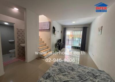 Spacious bedroom with attached bathroom and balcony access