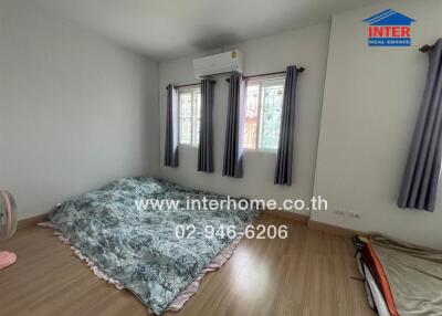Spacious bedroom with air conditioning and ample natural light