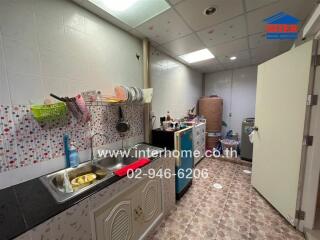 Interior kitchen with sink and storage cabinets