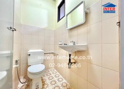 Minimalist bathroom with beige tiles and modern fixtures