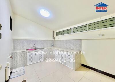 Compact and fully tiled kitchen with modern amenities