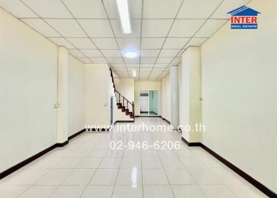 Spacious interior hallway with staircase and bright lighting