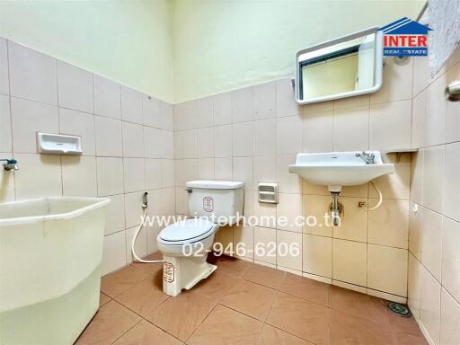 Clean and well-maintained bathroom with neutral tiles