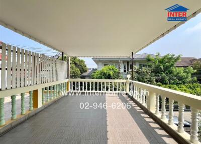Spacious balcony with railing and residential view