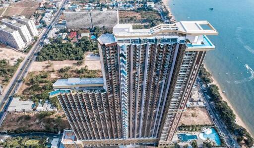 Aerial view of a modern high-rise residential building near the coastline