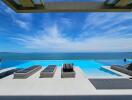 Luxurious infinity pool overlooking the ocean with sun loungers