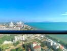 Panoramic coastal view from high-rise apartment balcony