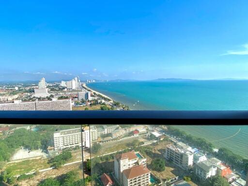 Panoramic coastal view from high-rise apartment balcony