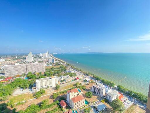 Aerial view of coastal cityscape with clear blue sky and sea