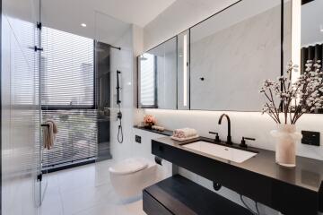 Modern spacious bathroom with large mirror and natural lighting