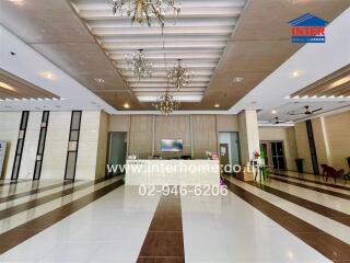 Spacious lobby area with elegant chandeliers and modern design