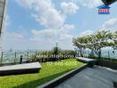 Spacious balcony with city skyline view and greenery