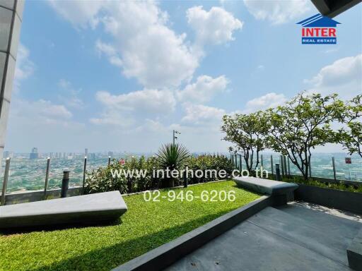 Spacious balcony with city skyline view and greenery