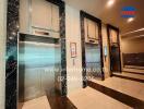 Elegant elevator lobby in a modern building with marble walls and digital display