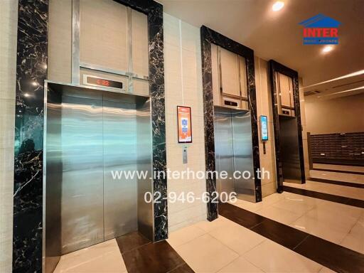 Elegant elevator lobby in a modern building with marble walls and digital display