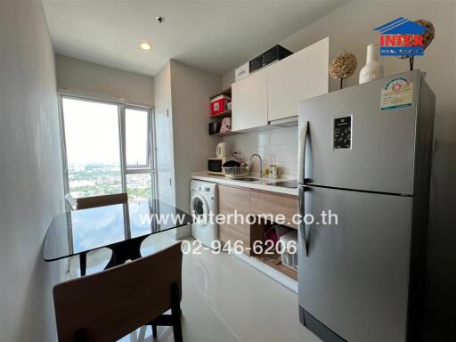 Modern compact kitchen with stainless steel appliances and city view