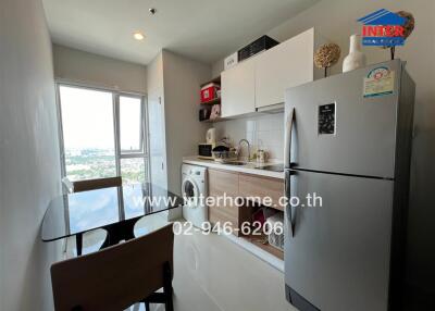 Modern compact kitchen with stainless steel appliances and city view