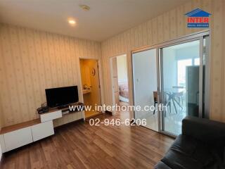 Spacious and well-lit living room with balcony access