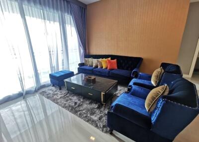 Elegant living room with blue velvet sofa and modern decor