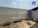 Outdoor side space with water tanks and empty planters