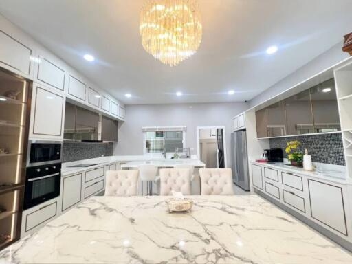 Modern kitchen with marble countertops and elegant lighting