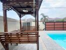 Spacious outdoor area with swimming pool and wooden gazebo