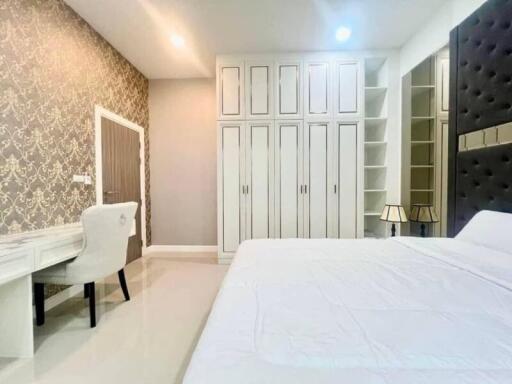 Elegant and modern bedroom with stylish wallpaper and ample storage
