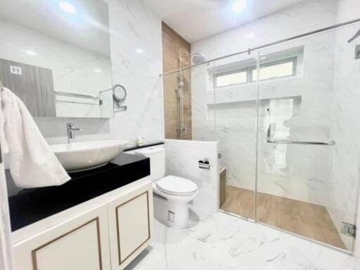 Modern bathroom with marble tiles and glass shower