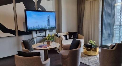 Modern living room with urban view, featuring elegant furniture and large TV