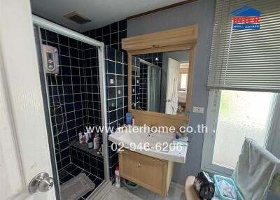 Compact bathroom with modern amenities and frosted window