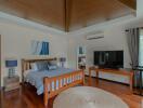 Spacious bedroom with wooden furniture and modern amenities